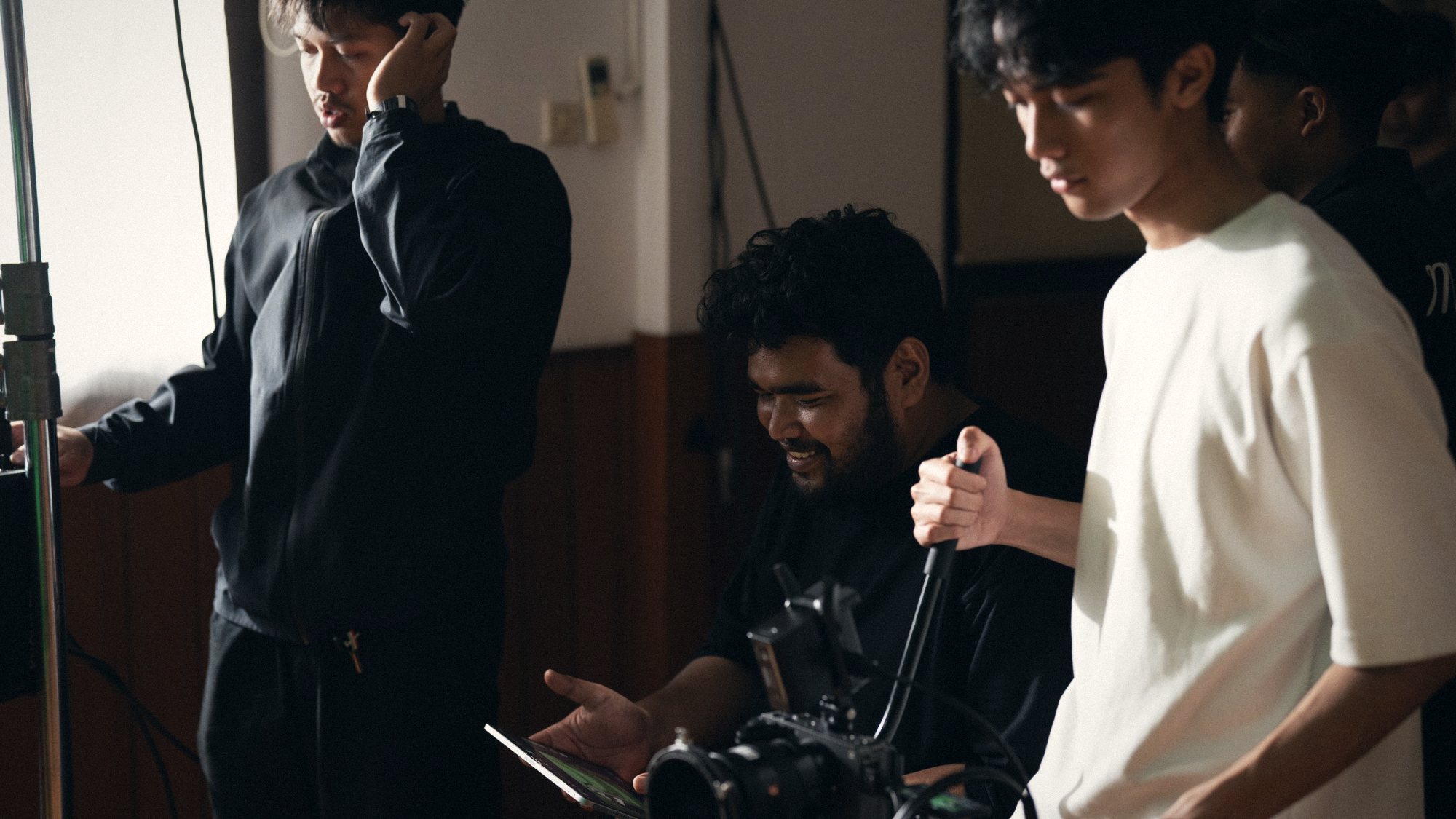 TREF crew reviewing a take on set