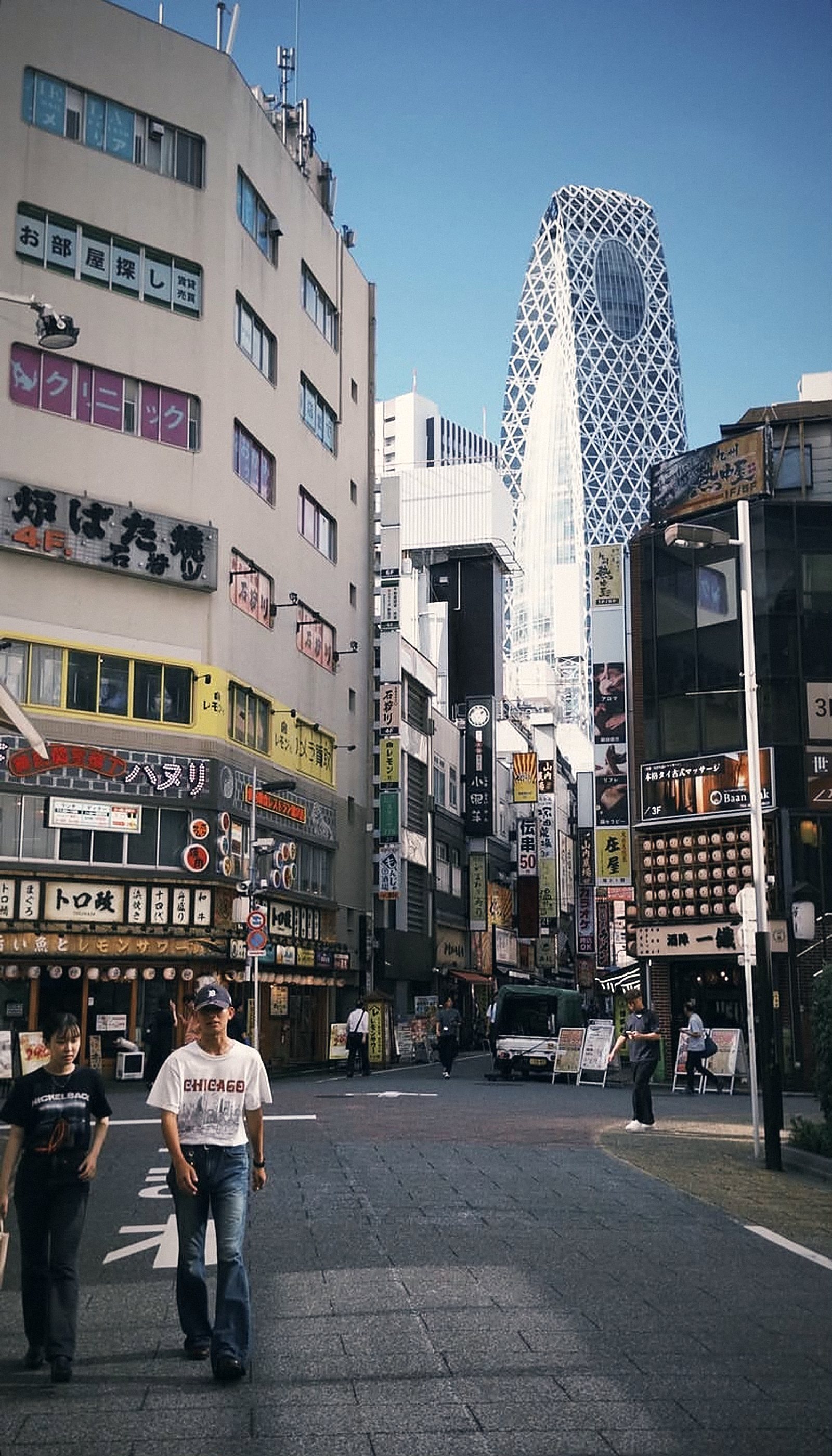Shinjuku side street with the Mode Gakuen Cocoon Tower in Tokyo