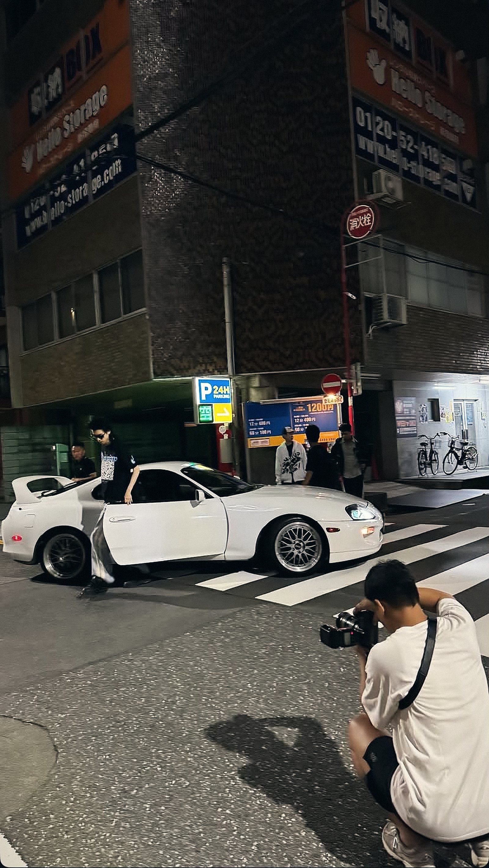 TREF photographer shooting a white sports car at night in Tokyo